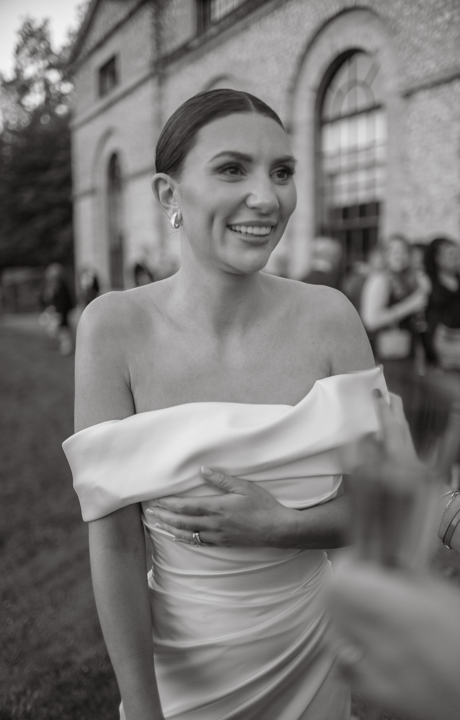 A series of candid shots showing a bride in an elegant white off-shoulder wedding dress.