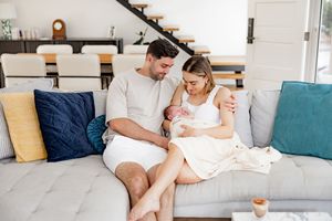 Young couple relaxing together while watching movie on laptop in modern living room.