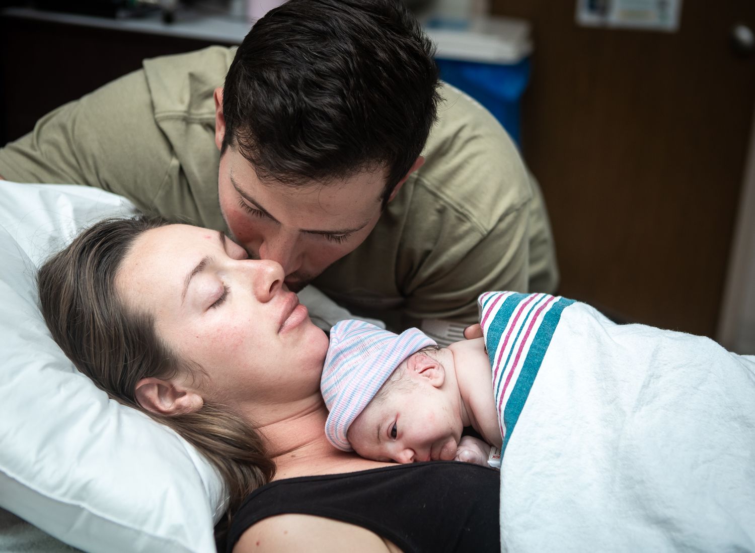 An exhausted mother is handed her baby after delivery at Thomas Hospital Fairhope. Baby is covered in vernix and crying
