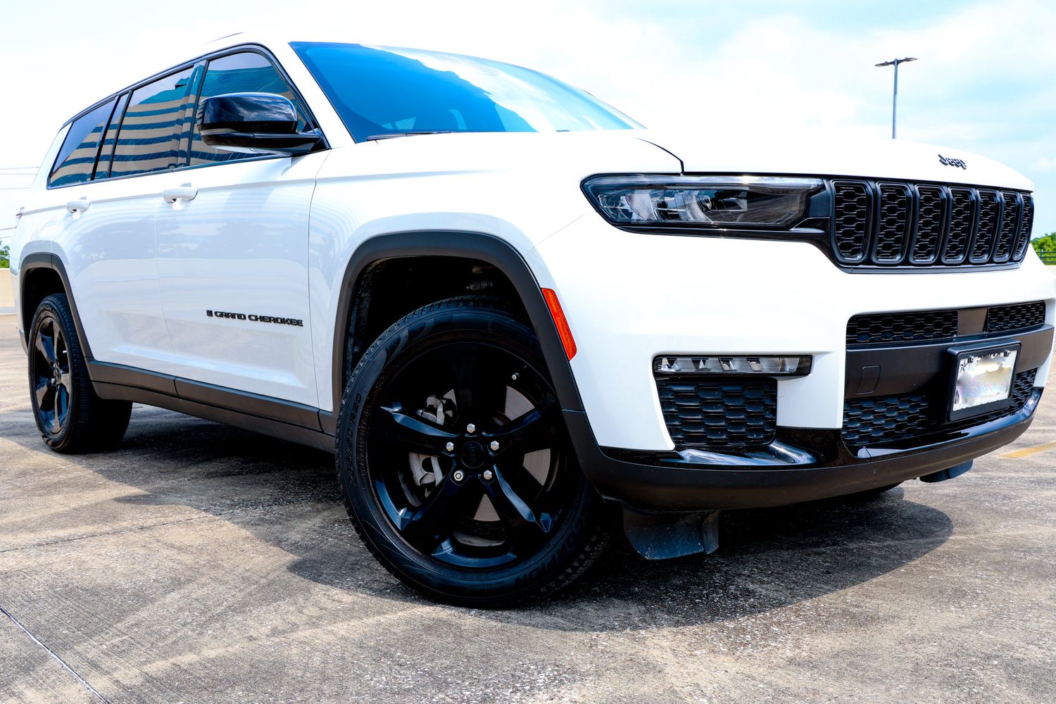 Multiple views of a white Jeep SUV showcasing its sleek profile and black accents against an urban backdrop.
