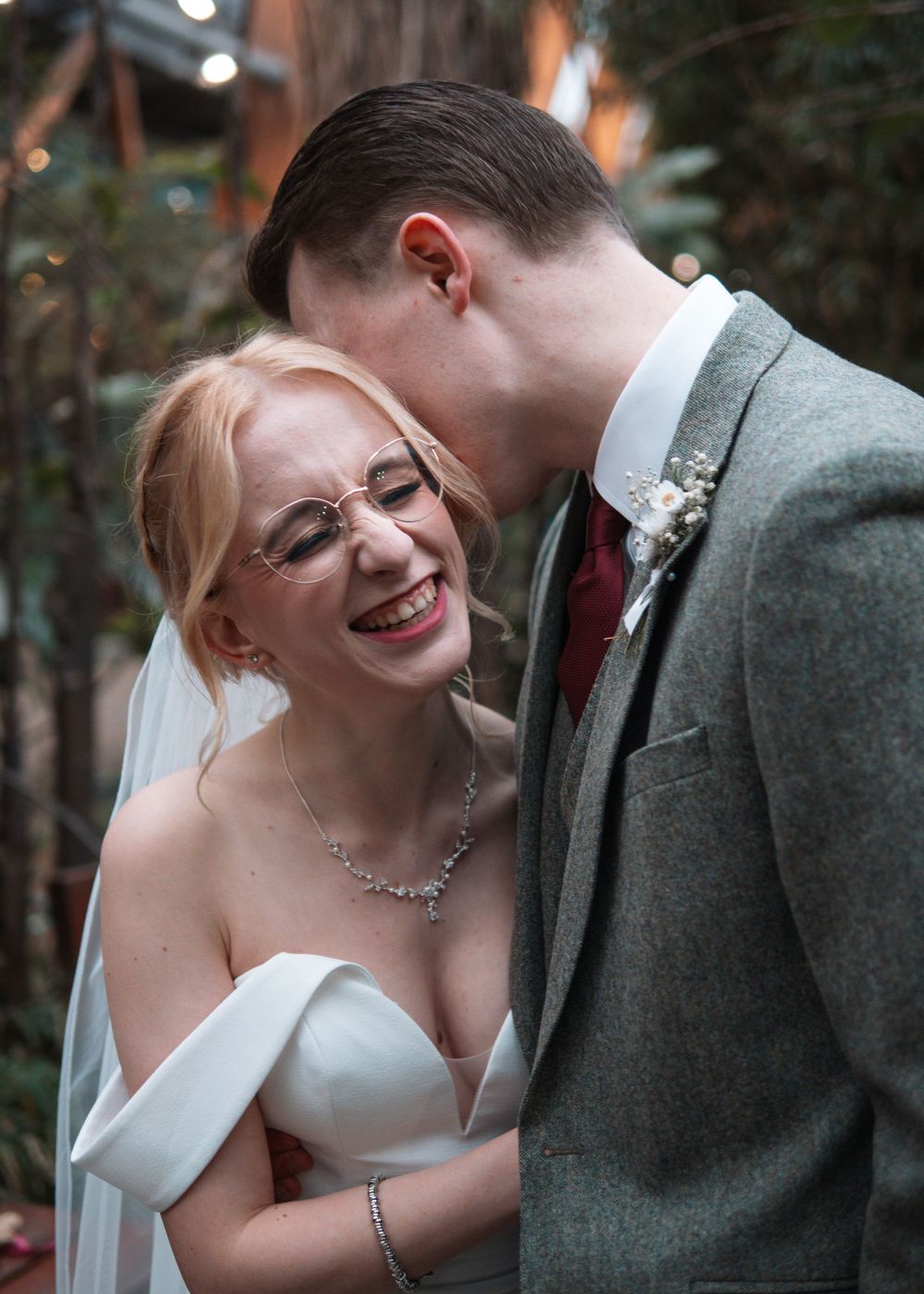 Sheffield Town Hall Wedding - A romantic moment captured between newlyweds in a garden setting.