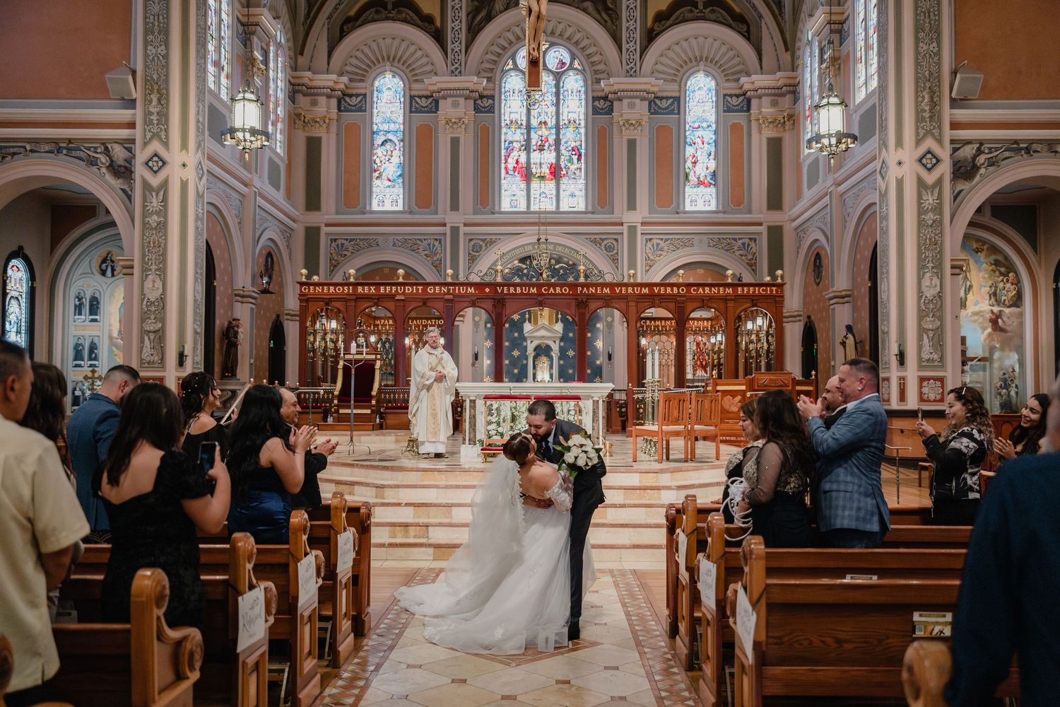 Sacramento Cathedral interior with stained glass windows during a wedding ceremony at the altar.