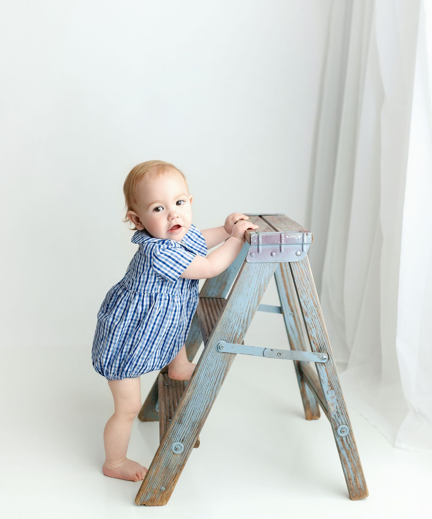 A 6-month milestone session with a little boy on a blue ladder. Greenville SC milestone Photographer, Easley, SC newborn photographer