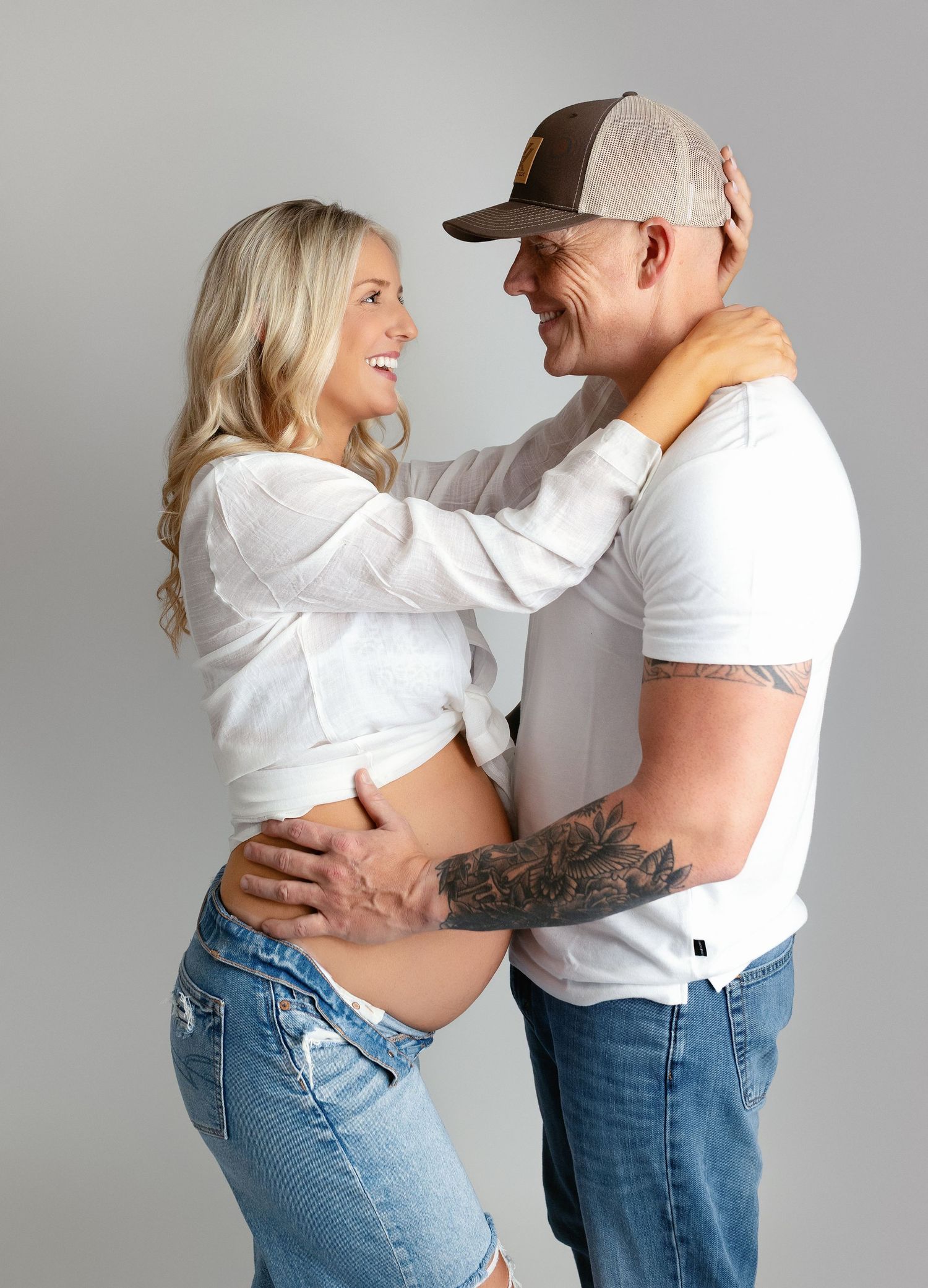 Mom and Dad are facing each other for their maternity shoot session. Greenville, SC newborn photographer, Easley SC newborn photographer