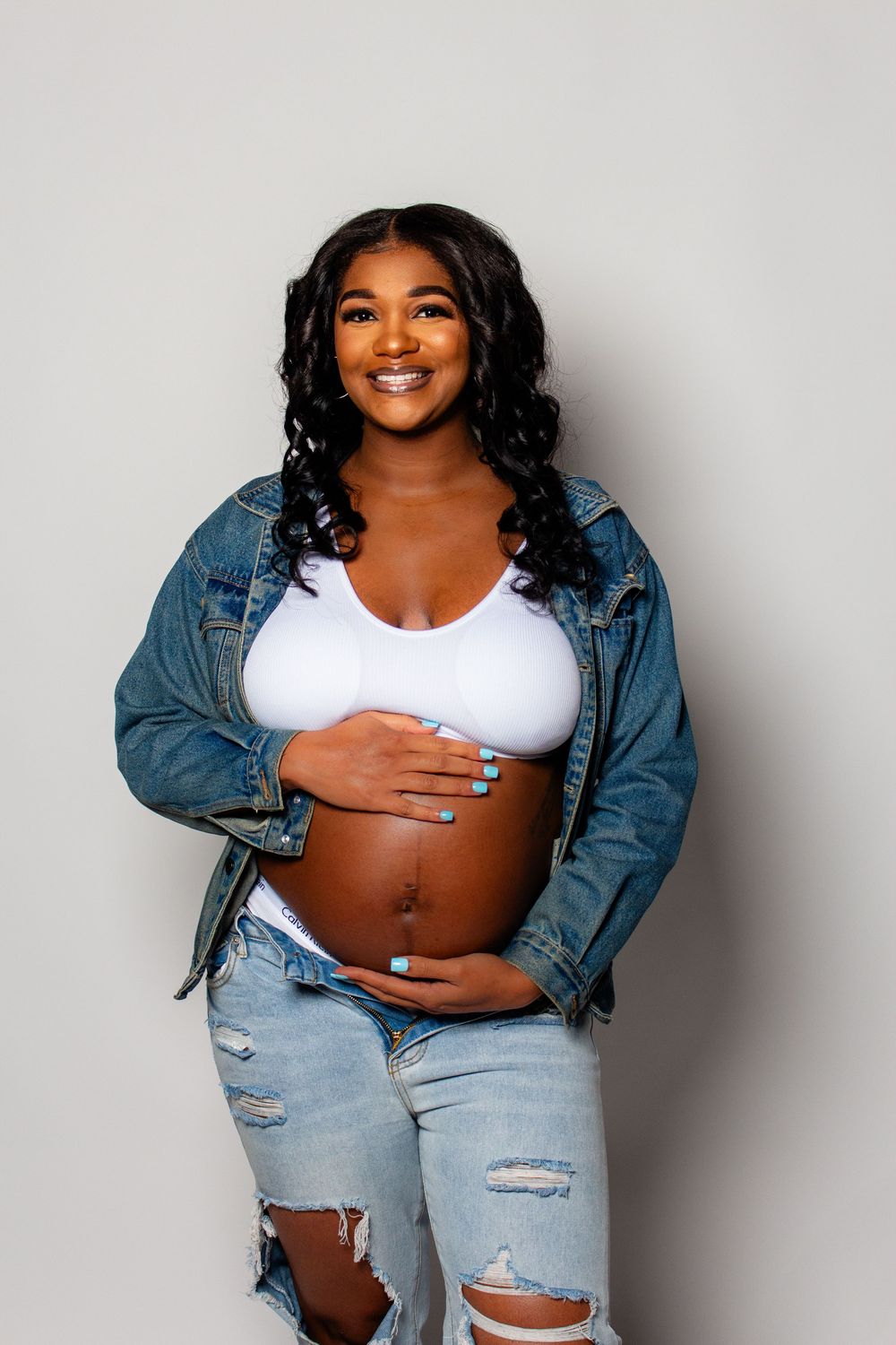 "Expectant mother glowing in natural light maternity portrait"