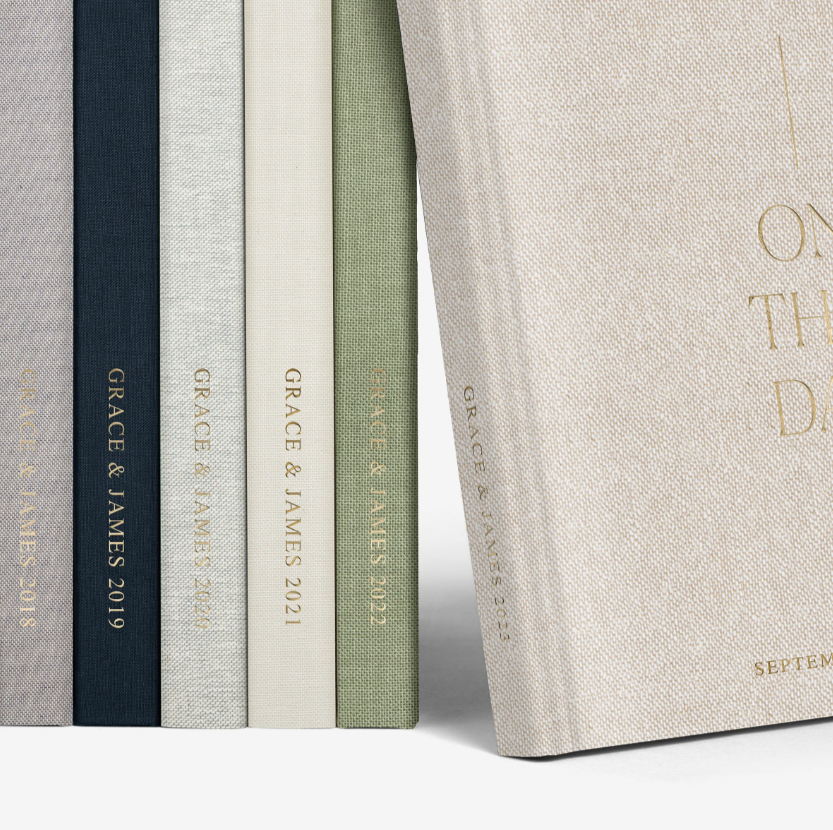 Artifact Uprising layflat wedding album with custom linen cover and seamless page design for panoramic photo spreads.