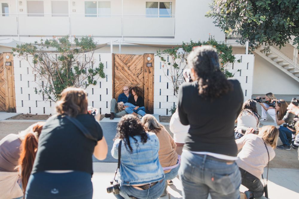 Multiple photographers capturing shots during an outdoor photo session.
