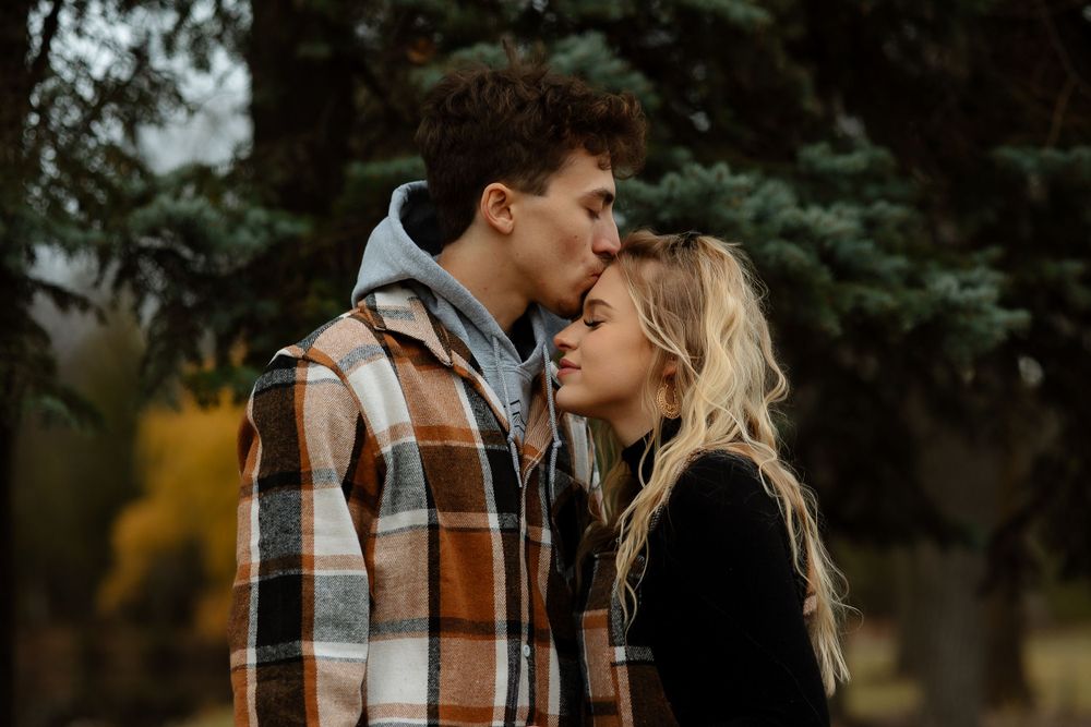 Romantic autumn portrait of a couple in matching plaid clothing.