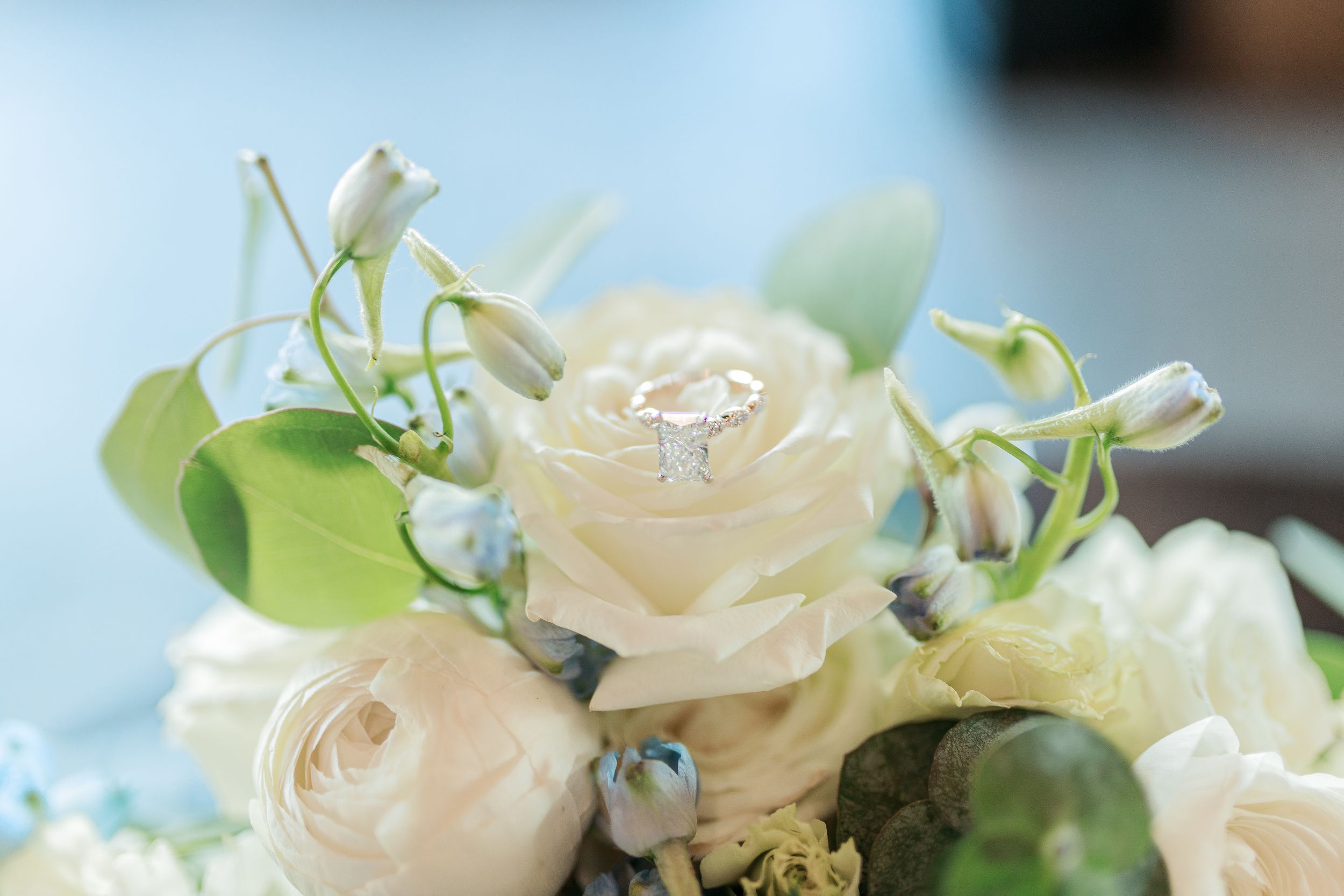 Light and airy bridal bouquet showcasing delicate blush roses with an elegant engagement ring on top - Midwest Luxury Wedding Photographers