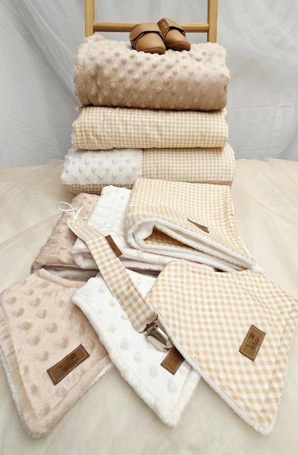 Soft baby blanket with giraffe and animal print pattern in neutral beige tones with white minky dot fabric.