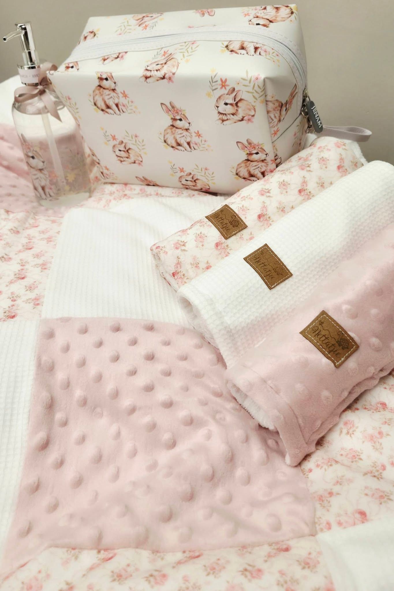 Pink baby gift set with bunny print bag, waffle blanket, and minky dot pillow in soft blush tones.