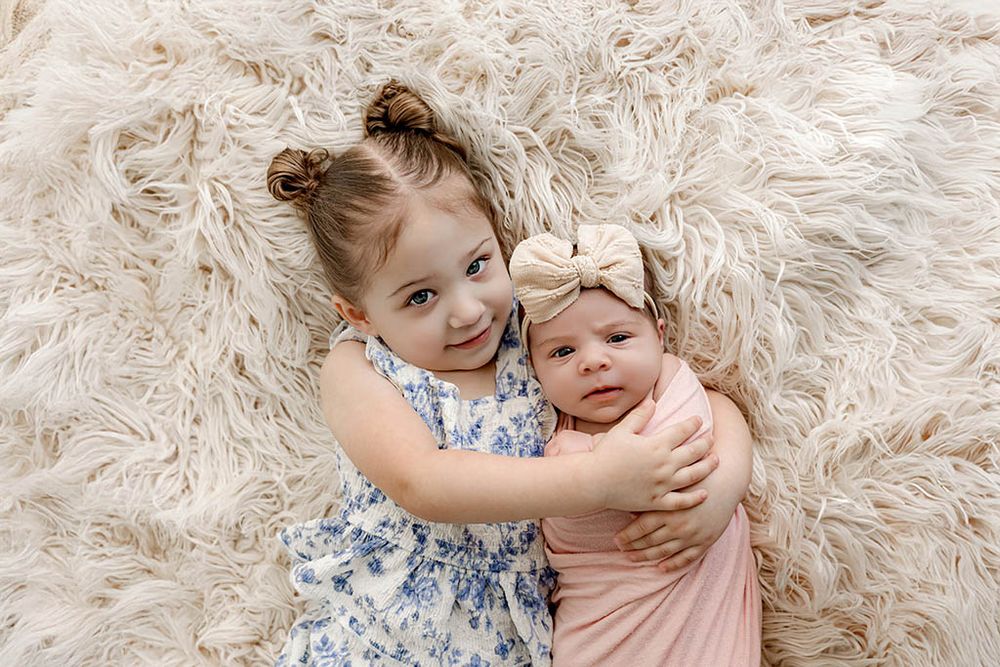 Sibling photos of two sisters by Winchester CA newborn photographer.