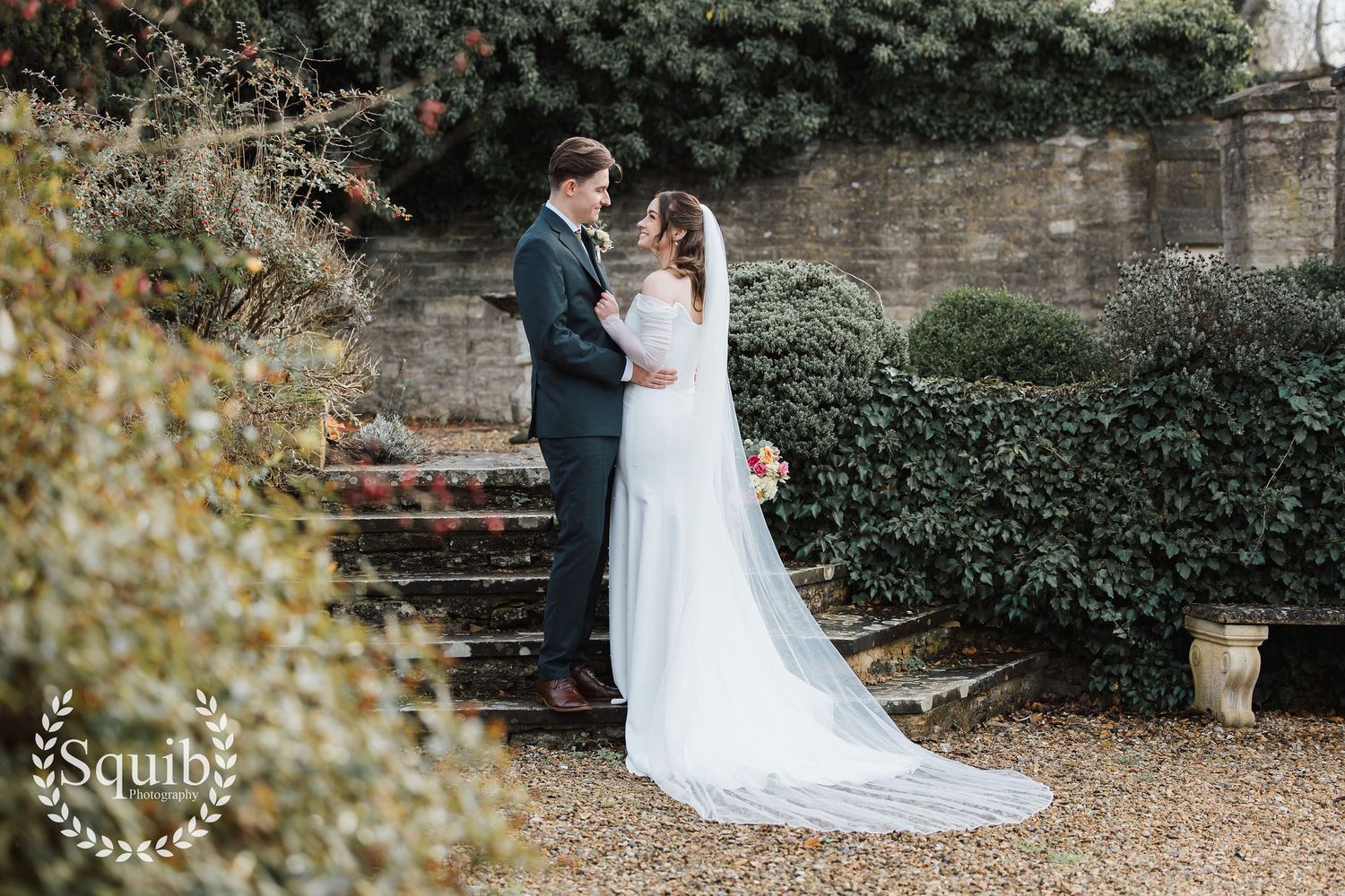 Bride and groom sharing romantic moment in winter garden at Minster Mill