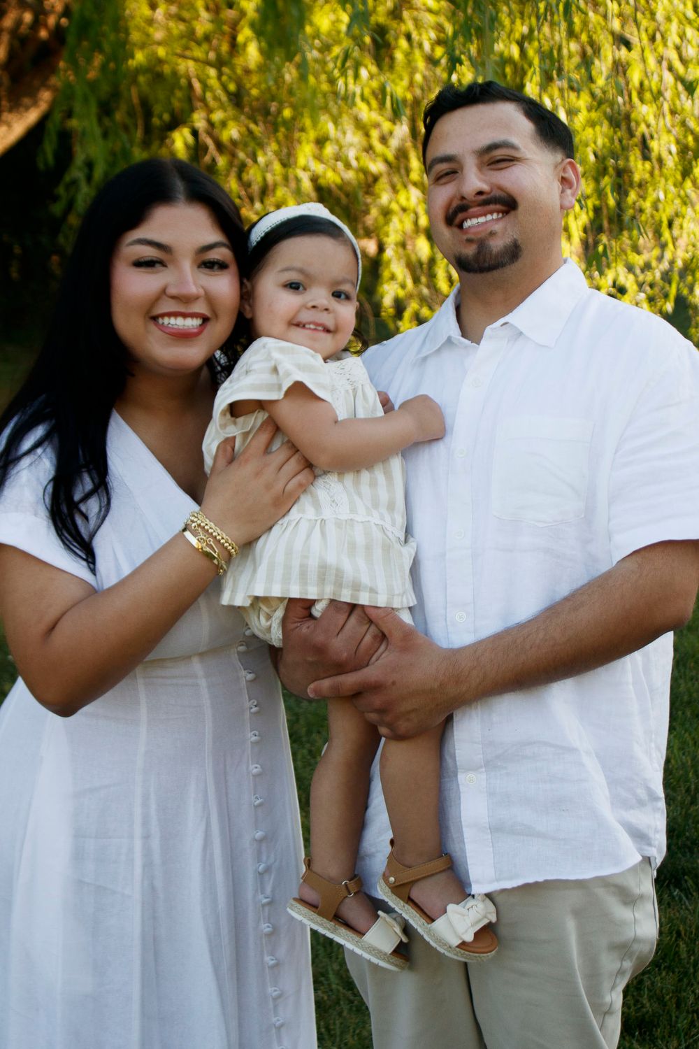 A family of three during a family photo session at Willow Tree Park in Canyon, Texas