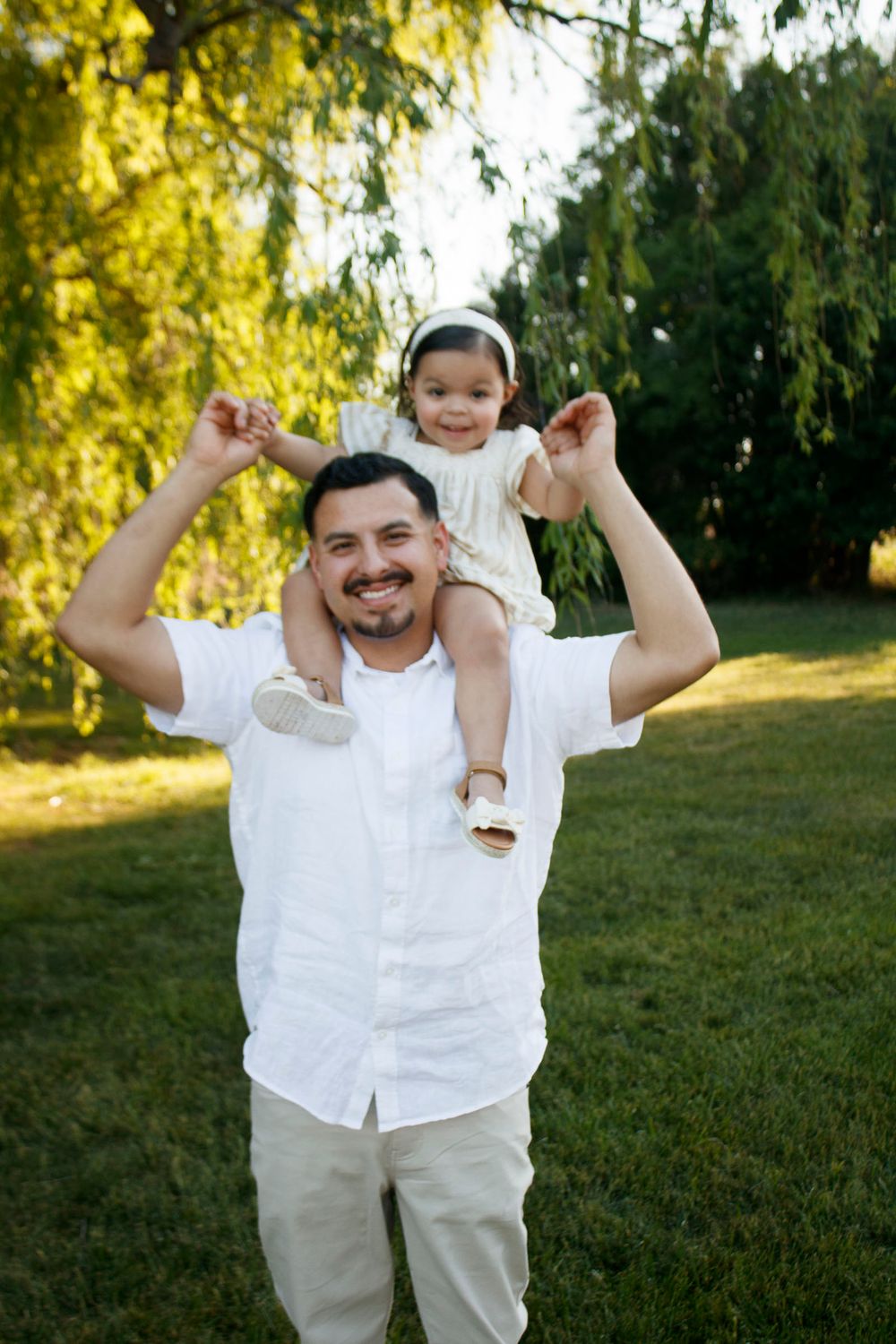 A father and daughter during a family photo session at Willow Tree Park in Canyon, Texas