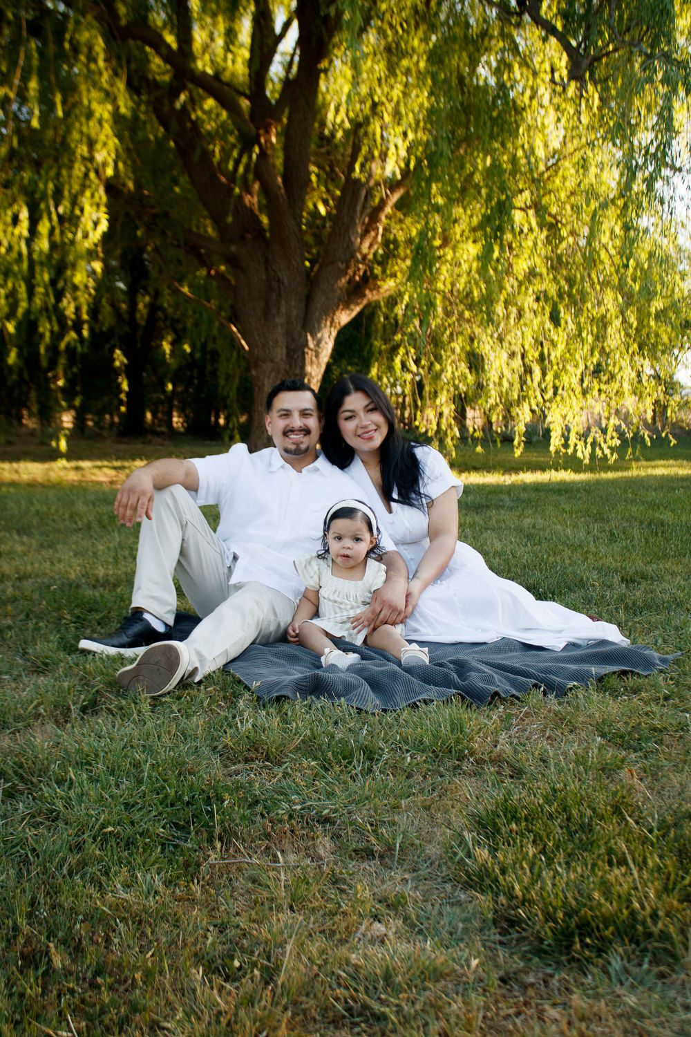 A family of three during a family photo session at Willow Tree Park in Canyon, Texas
