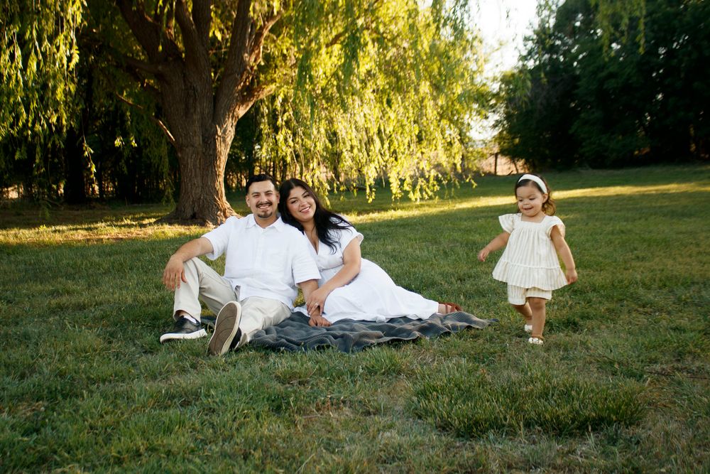 A family of three during a family photo session at Willow Tree Park in Canyon, Texas
