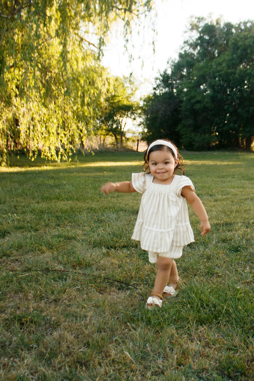 A toddler girl during a family photo session at Willow Tree Park in Canyon, Texas