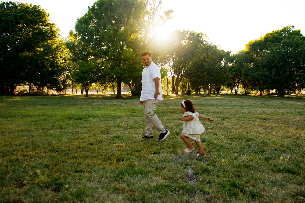 A father and daughter during a family photo session at Willow Tree Park in Canyon, Texas