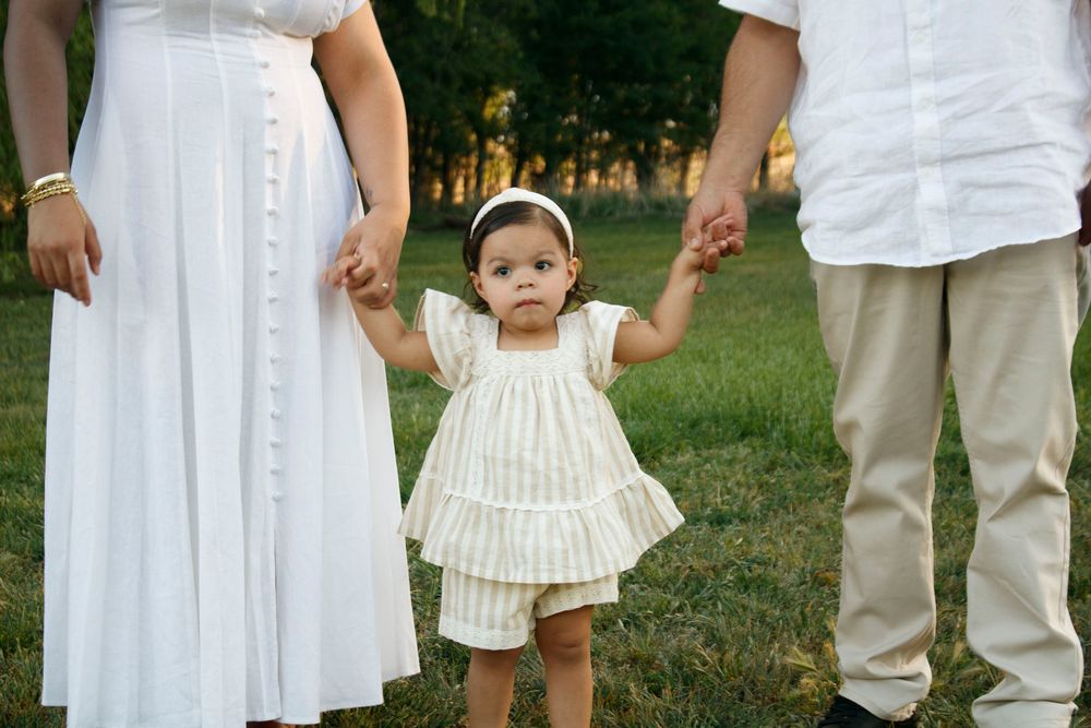A family of three during a family photo session at Willow Tree Park in Canyon, Texas