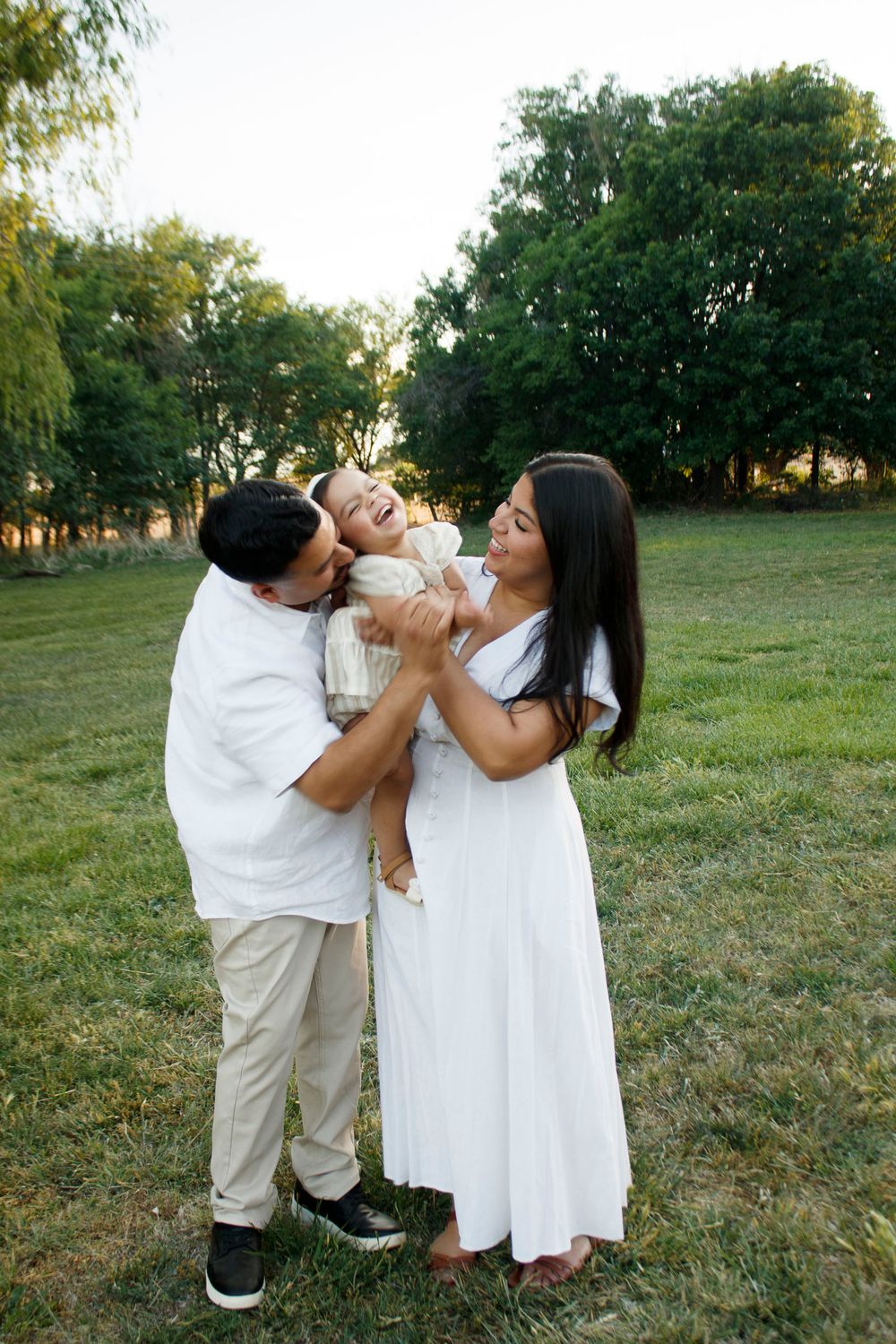 A family of three during a family photo session at Willow Tree Park in Canyon, Texas