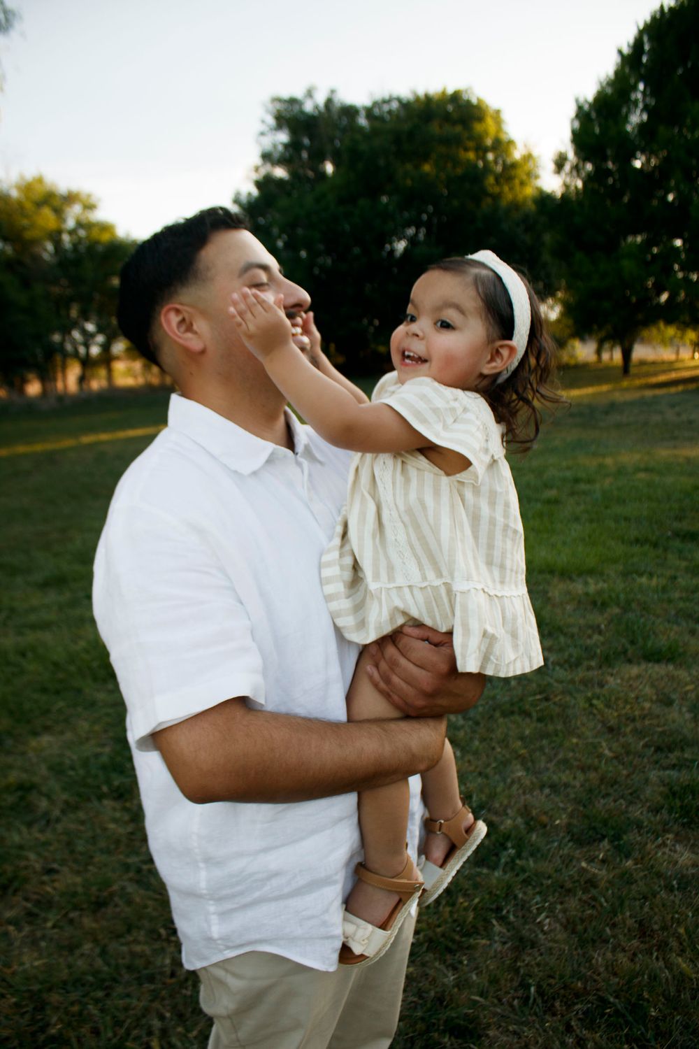 A father and daughter during a family photo session at Willow Tree Park in Canyon, Texas