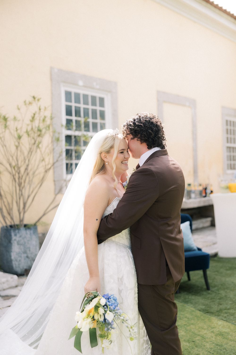 Candid portrait of bride and groom inside a historic Portugal wedding villa
