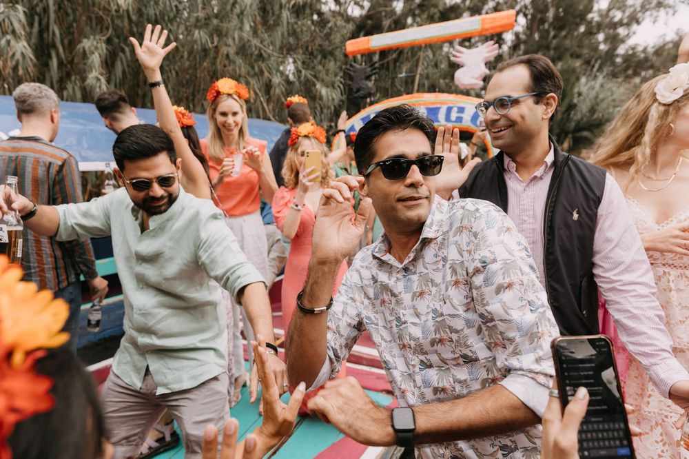 Group of friends dancing and celebrating at a vibrant outdoor party event.
