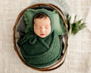 Baby wearing green during newborn photoshoots with Tiffany Bergamino Photography in Fort Wayne Indiana