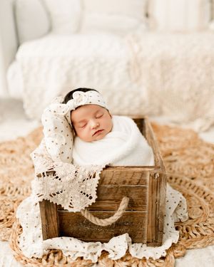 Baby newborn girl in box during studio newborn photography photoshoot with Tiffany Bergamino Photography