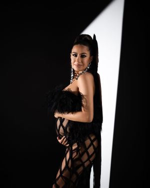 Fashion portrait with black lattice dress and dramatic side lighting.