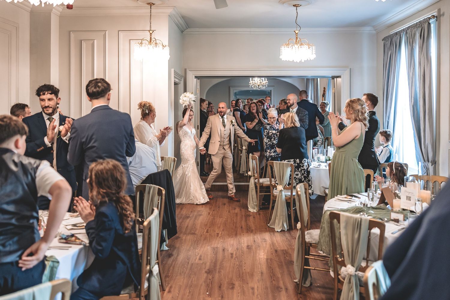 A reception entrance celebrated by the couples family and friends at Dunedin House.
