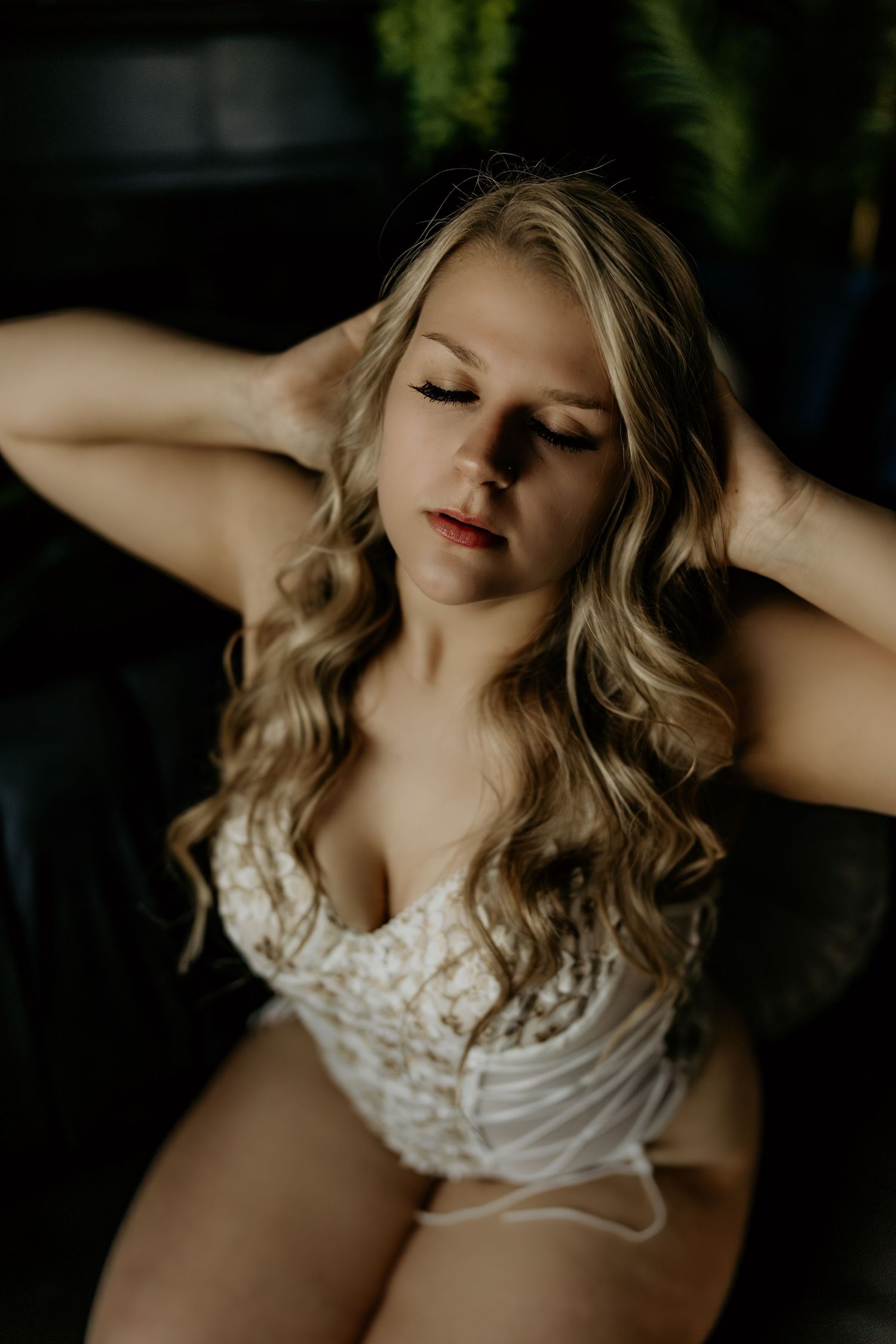 Artistic boudoir photography featuring soft lighting and lace details.