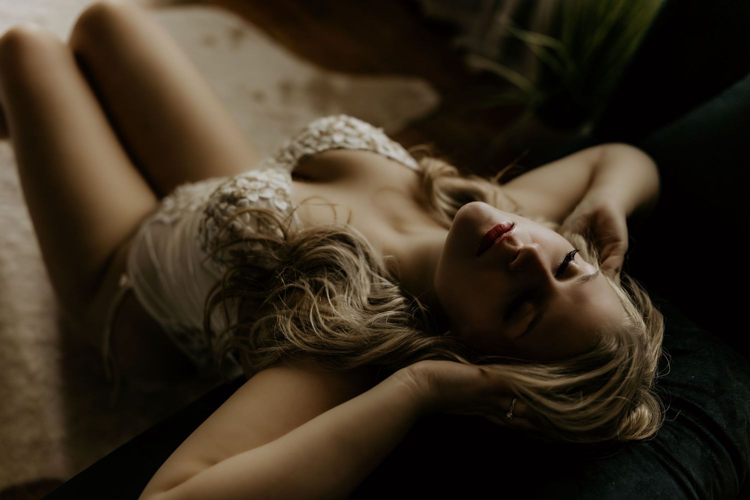 Artistic black and white boudoir photography with dramatic lighting and shadows.