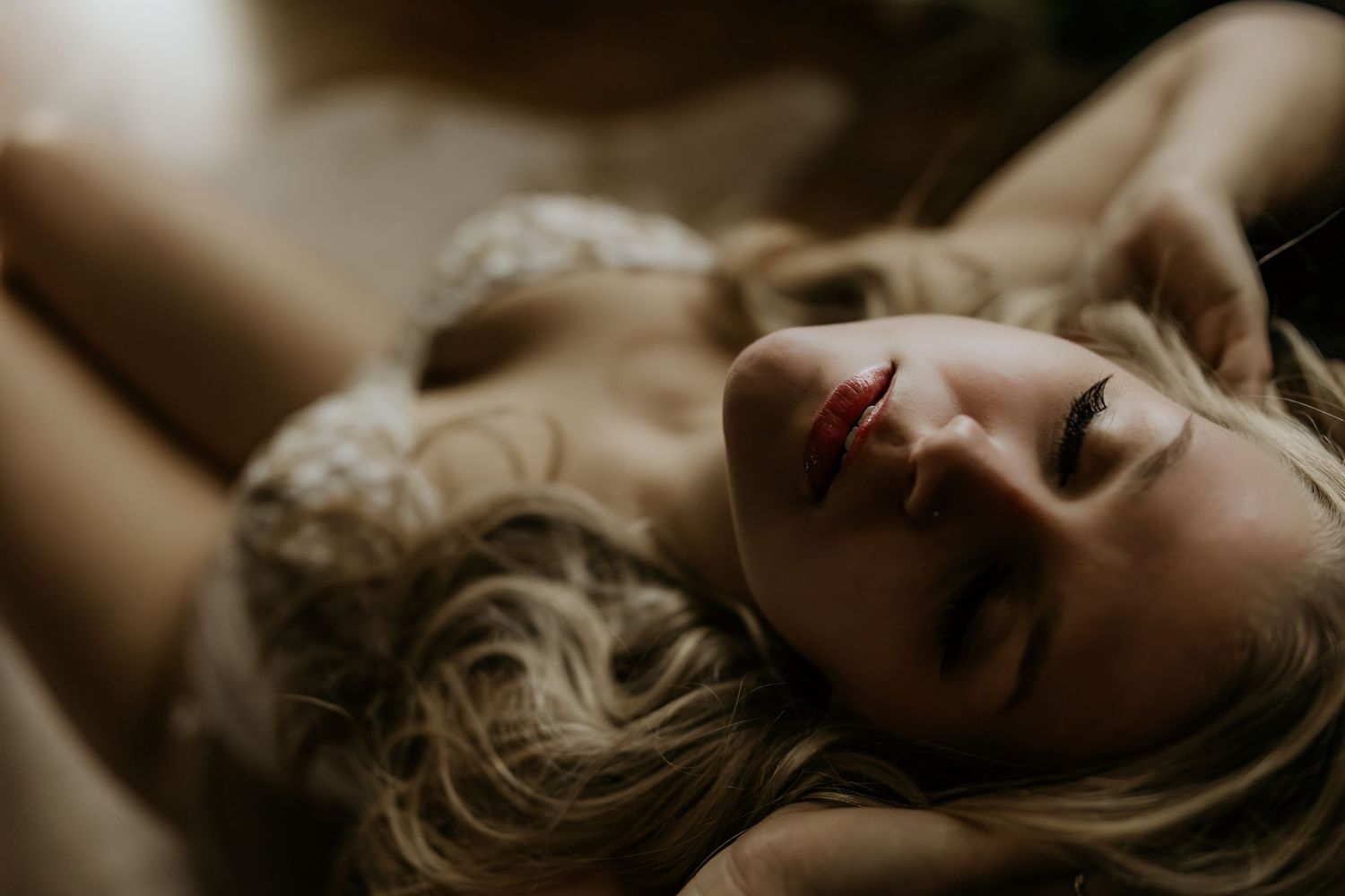 Artistic sepia-toned portrait in dramatic lighting.