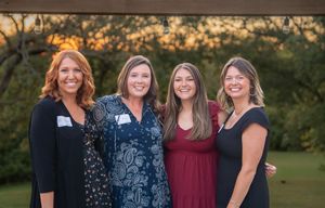 Group of friends posing together outdoors at sunset during a casual gathering in a park setting. Quad Cities Event Photography
