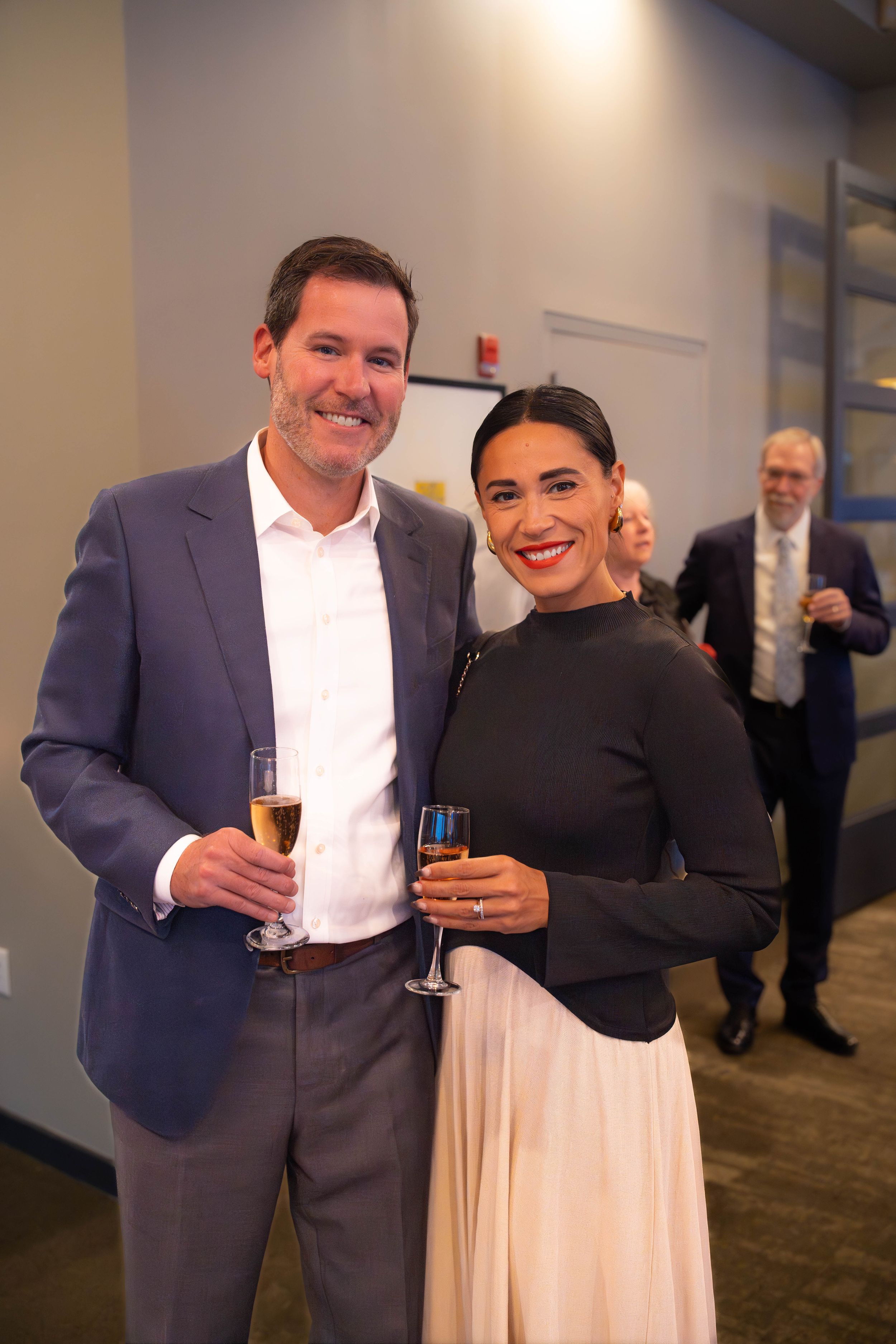 Attendees socializing at an evening business function in a modern office space. Quad Cities Event Photography
