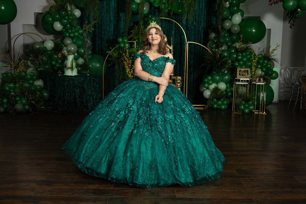 Indoor celebration venue with emerald green decor and elegant formal atmosphere.