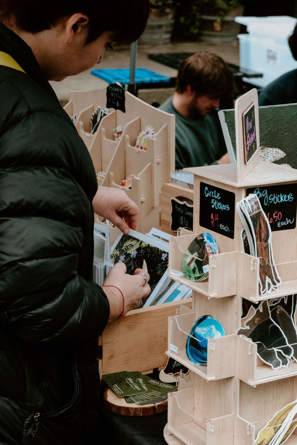 Wooden display stands showcasing handmade crafts at a local market.