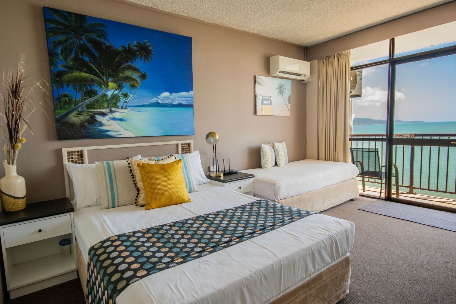 Bright oceanview hotel suite with coastal decor and panoramic windows.