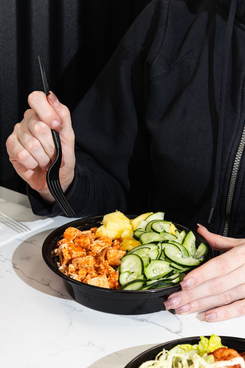 Tofu bowl with fresh pineapple and cucumber slices shot by Rosslyn Maria Vancouver Food Photographer for Konala in Spokane Washington.