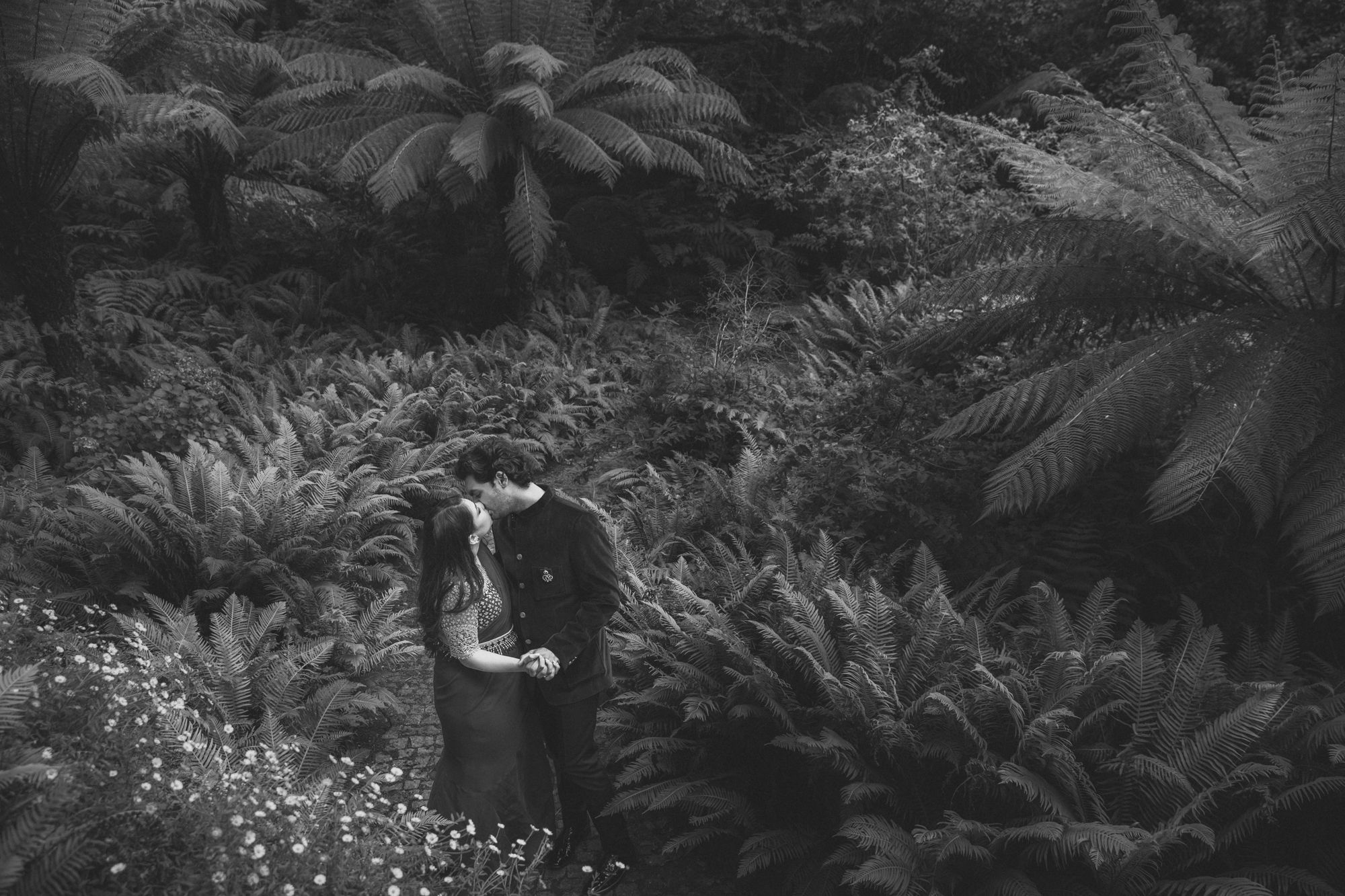 A breathtaking beach photoshoot in Sintra during a Destination Indian Wedding in Portugal, with the couple embracing atPena palace gardens