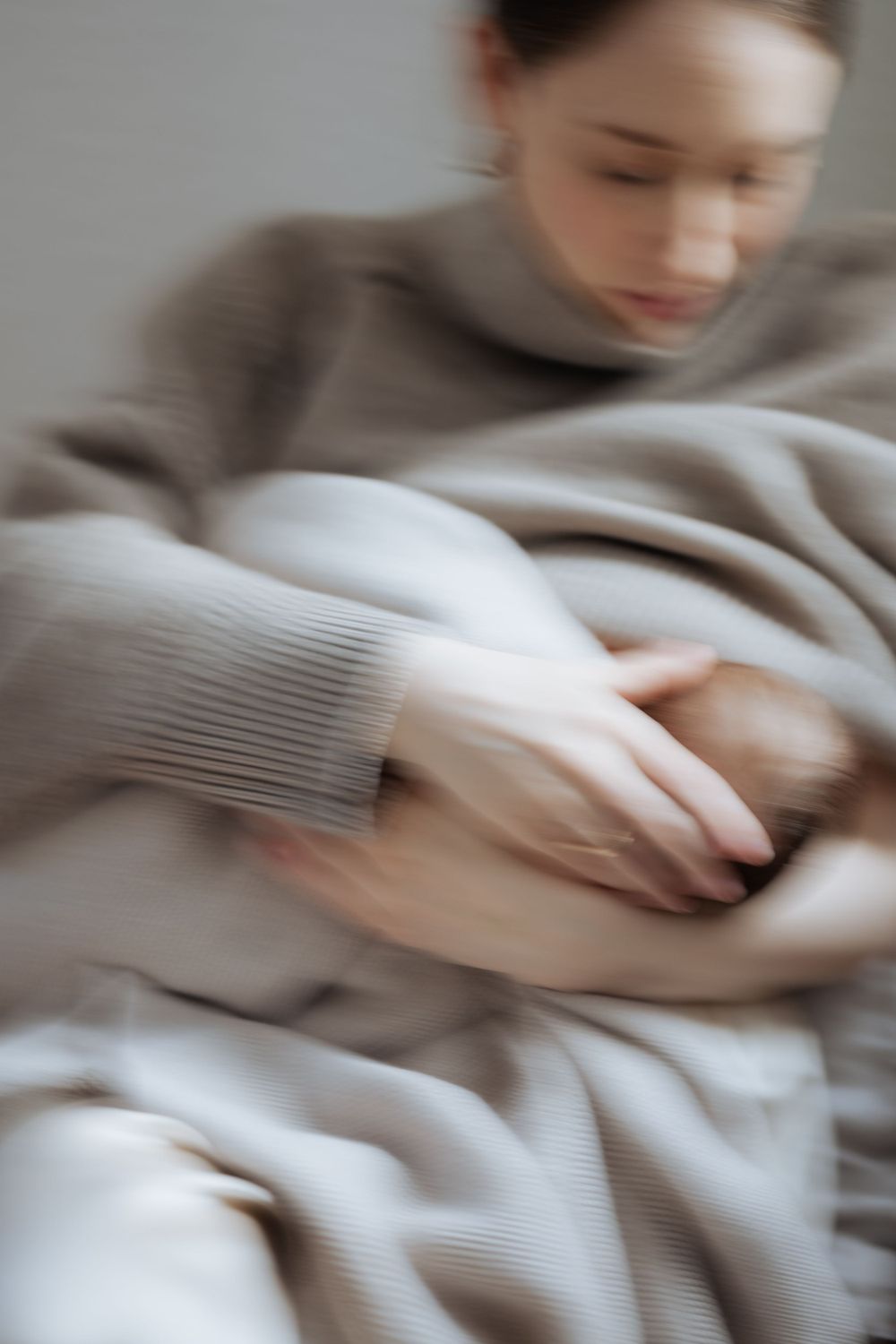 Abstract motion blur of soft gray textiles in natural light.