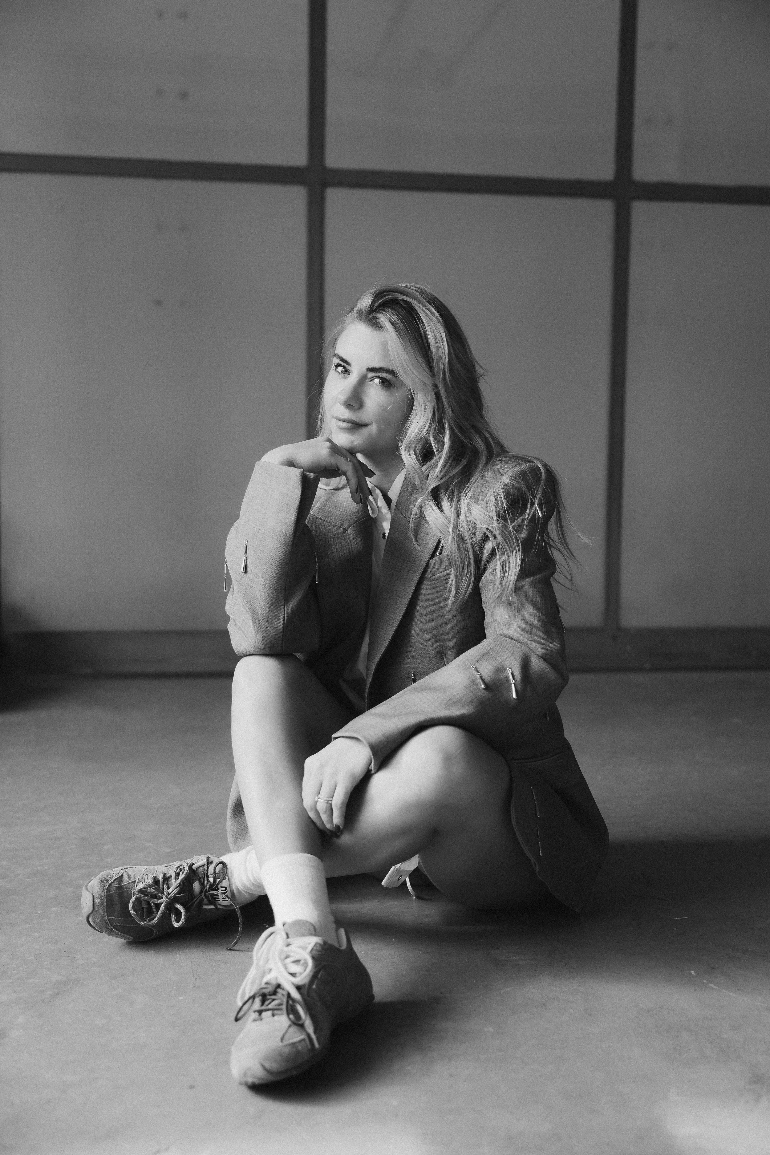 A black and white photo series showing a person lying on the floor in different curled up positions.
