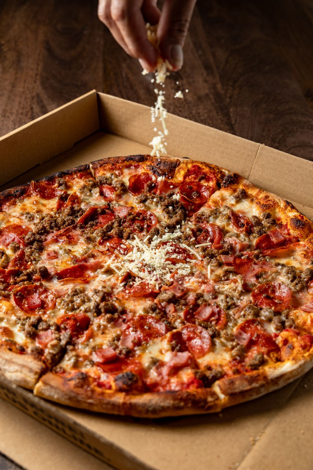 Sequence of pizza photos showing multiple hot stone-baked pizzas with melted cheese and toppings in a cardboard box.
