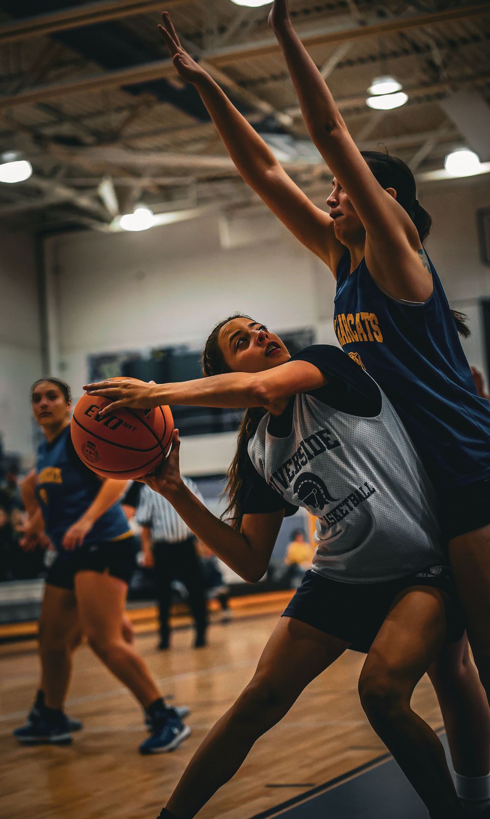 Two basketball players battle for position during an intense game moment.