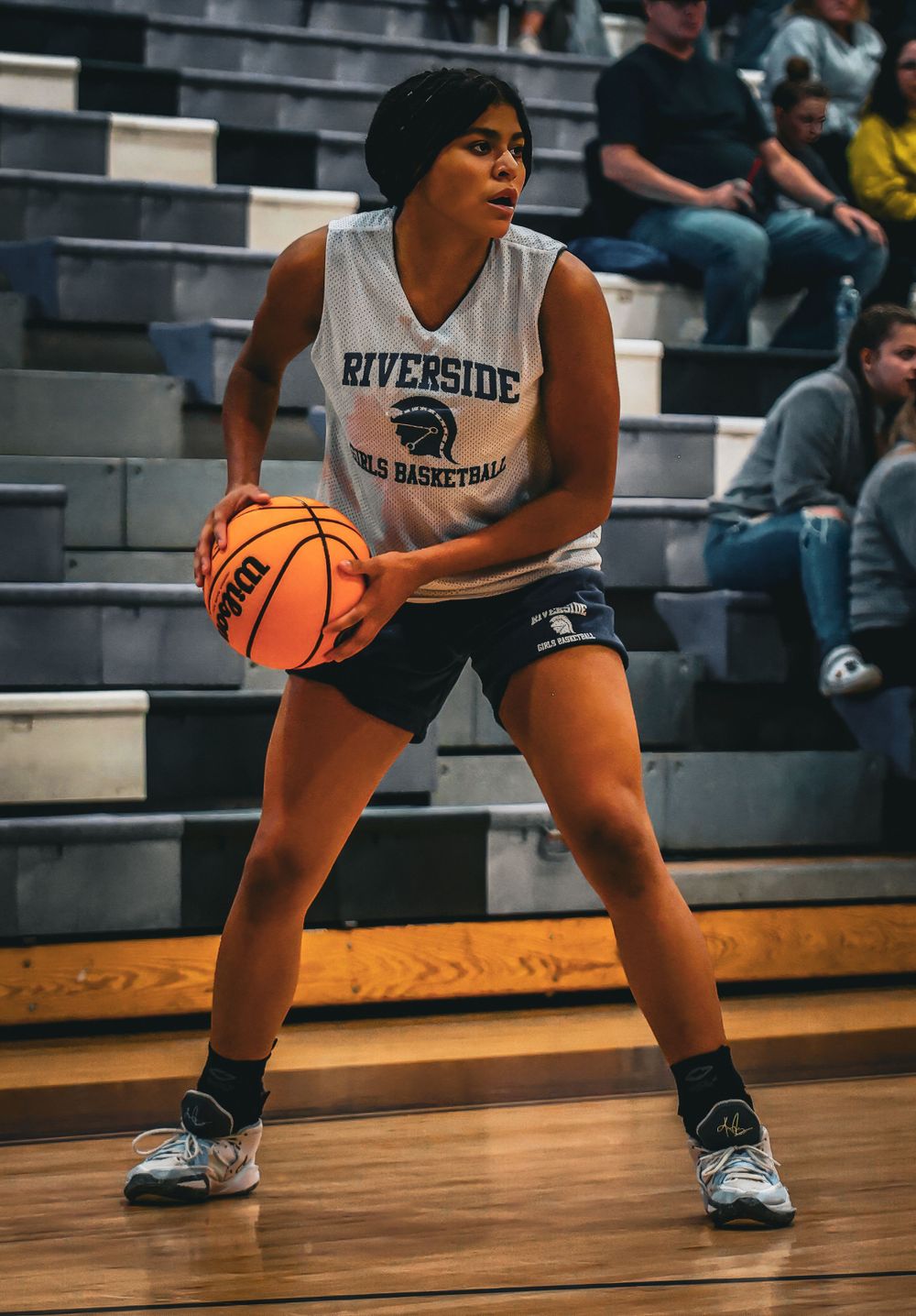 Basketball player in Riverside uniform prepares to make a play from triple-threat position.