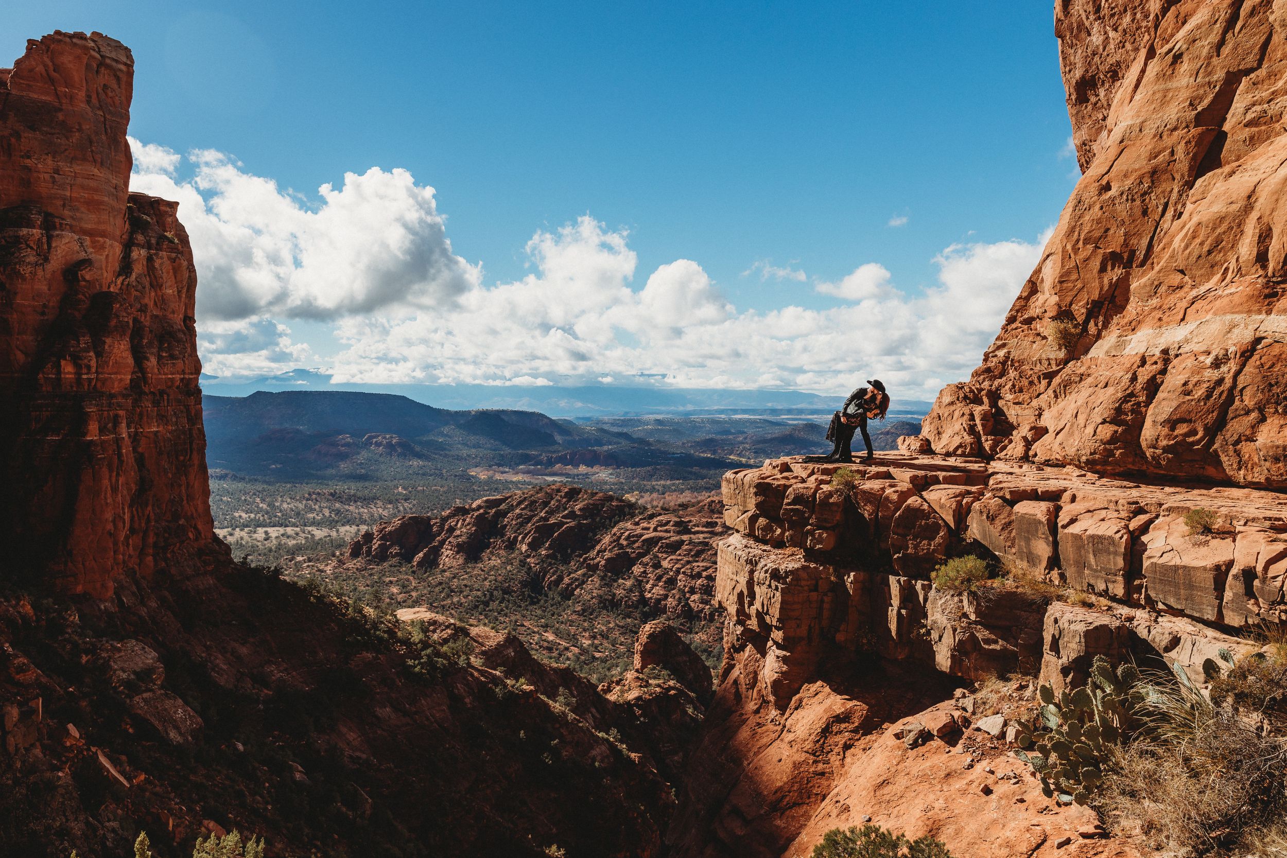 Stunning landscape view of red rock canyons and distant mountains under blue skies.