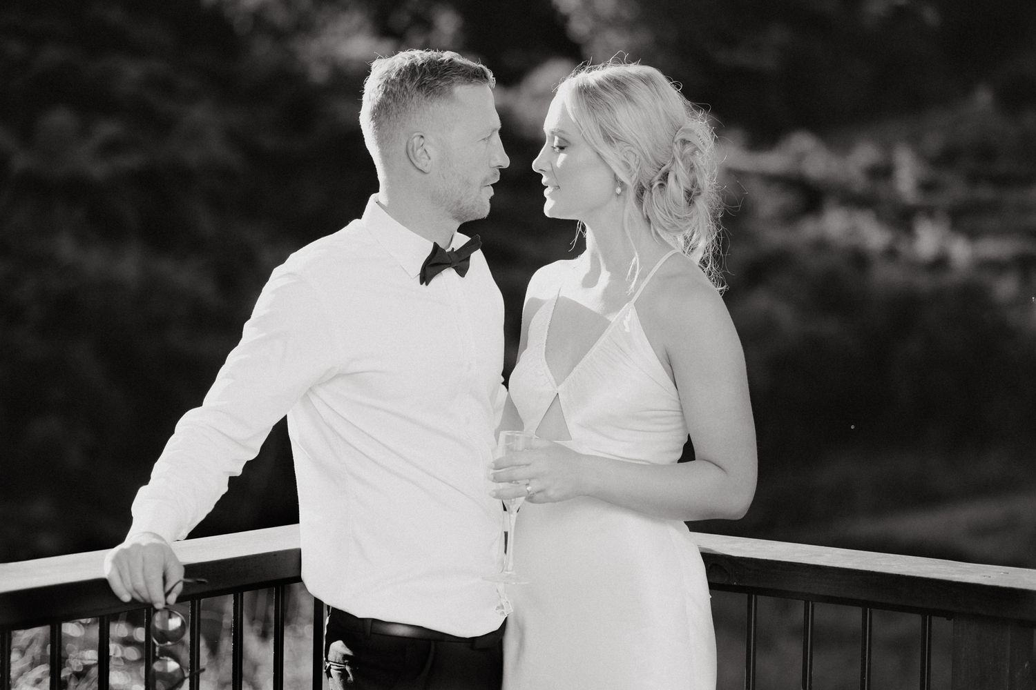 A romantic black and white photo of a couple in wedding attire, captured by Apertured Media Auckland Wedding Photographer.