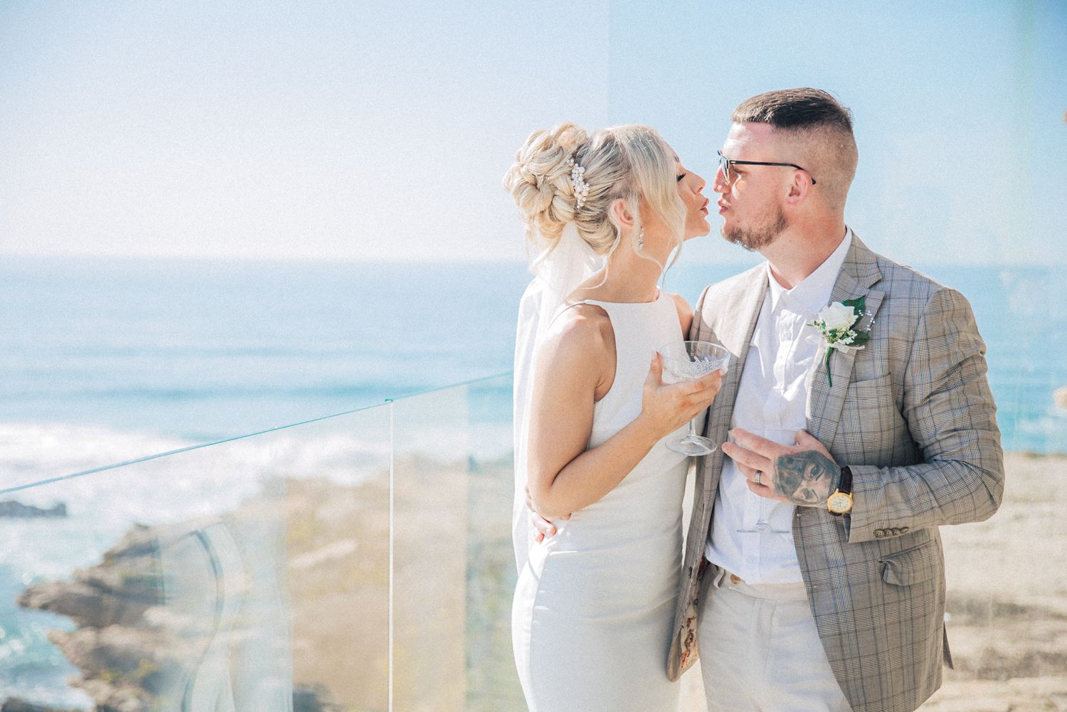 Intimate sunset kiss between bride and groom at Arriba by the sea wedding venue, captured in Portugal by a destination wedding photographer